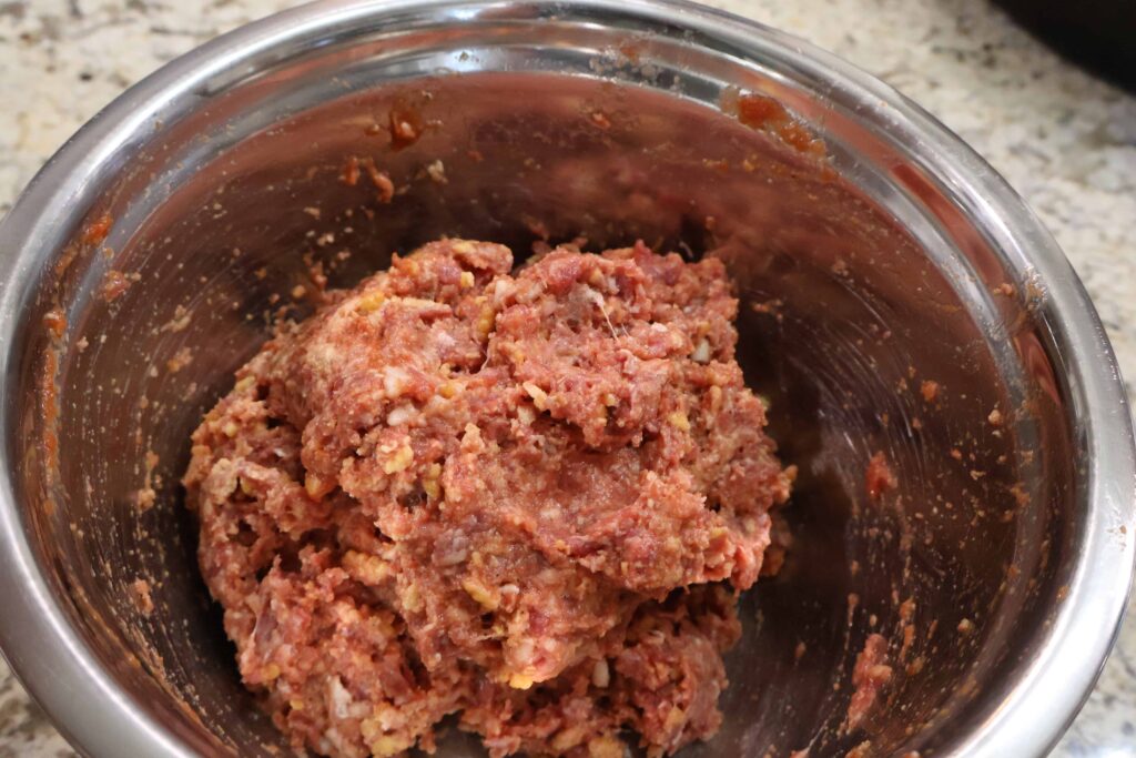 meat loaf mixture mixed up in stainless steel bowl
