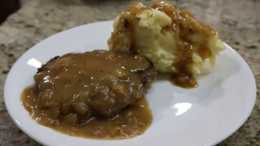 Salisbury steak on plate with mashed potatoes and gravy