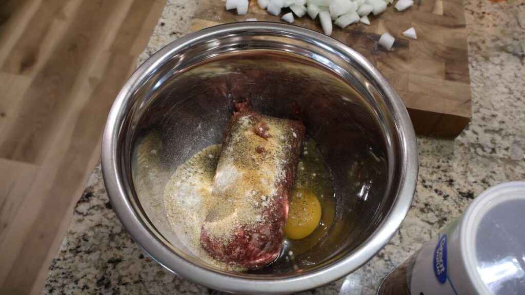 meat mixture in stainless steel mixing bowl