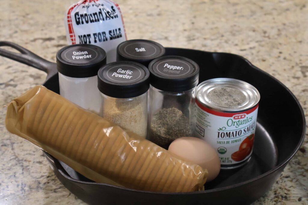 ingredients for southern meatloaf with crackers displayed in a cast iron skillet