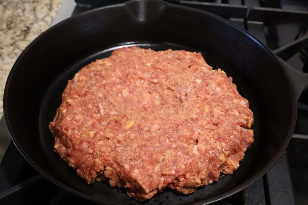 meatloaf mixture in a cast iron skillet