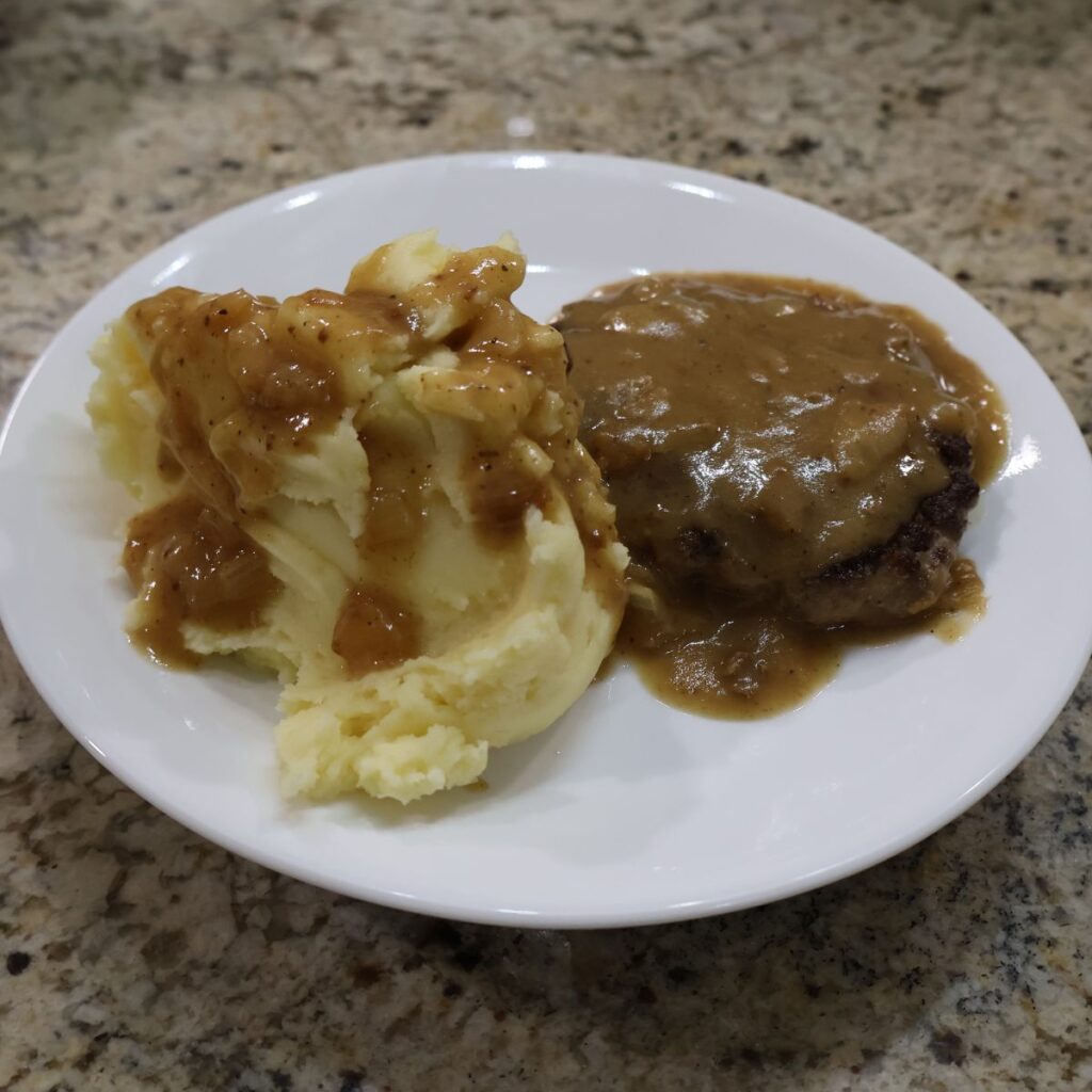 mashed potatoes with gravy and hamburger steak