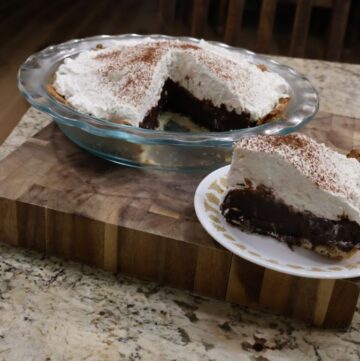 sliced full pie and the pie slice plated from chocolate pie