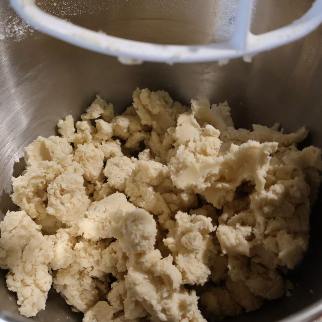 stand mixer pie crust dough in mixing bowl