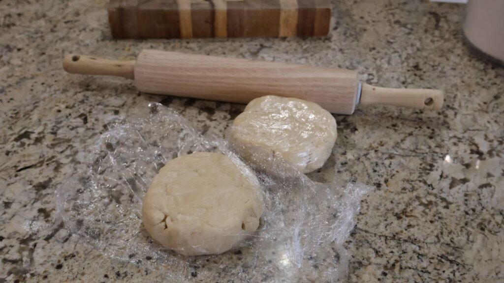 2 pie dough discs by rolling pin