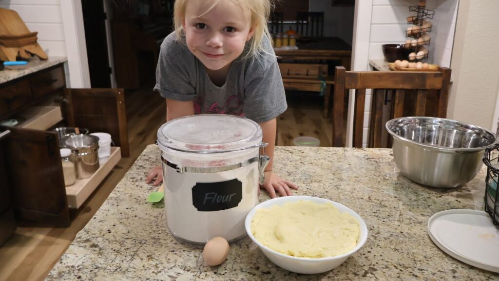little girl with potato fritter ingredients