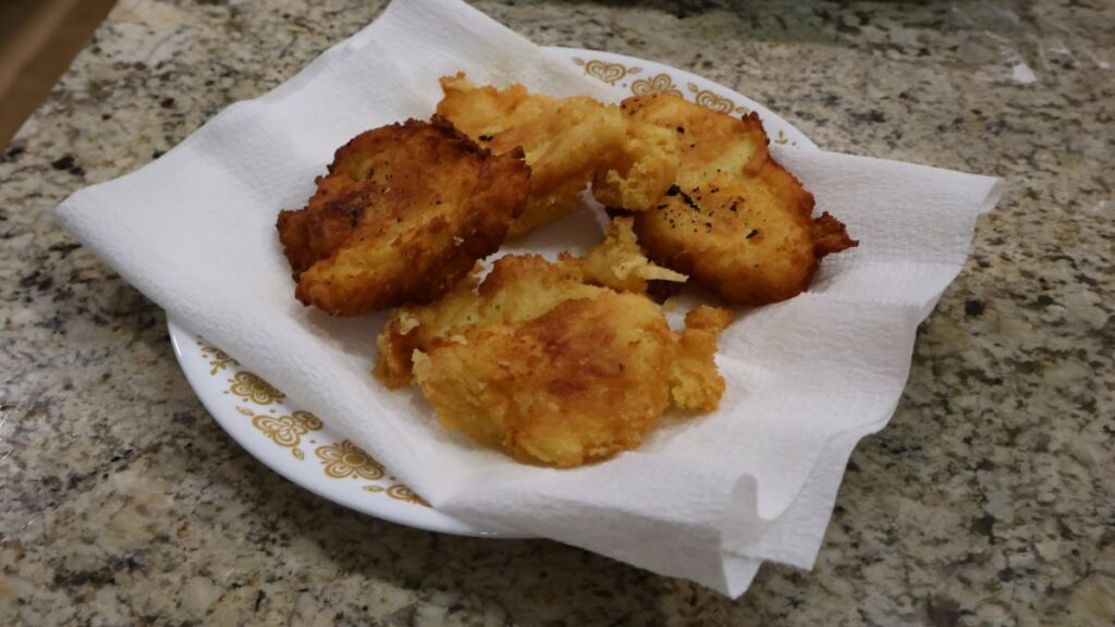 potato fritters on paper towel lined plate