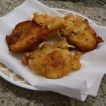 potato fritters on paper towel lined plate