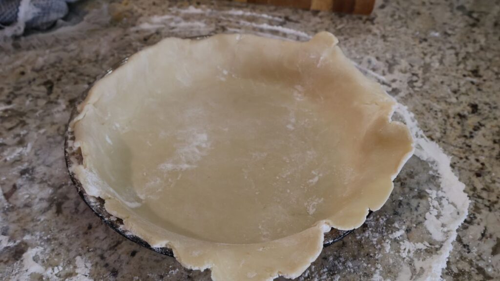 rolled out in pie dish with rough edges