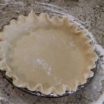 Raw stand mixer pie crust in pie pan