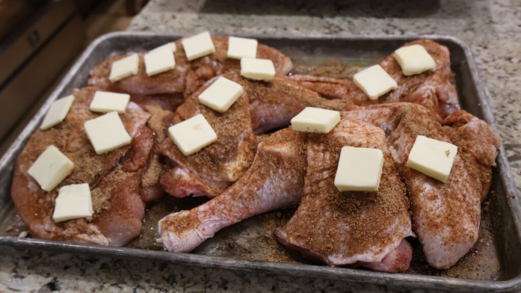 seasoned turkey pieces with slices of butter on top