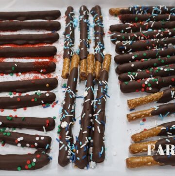 chocolate covered pretzel rods with sprinkles on sheet pan