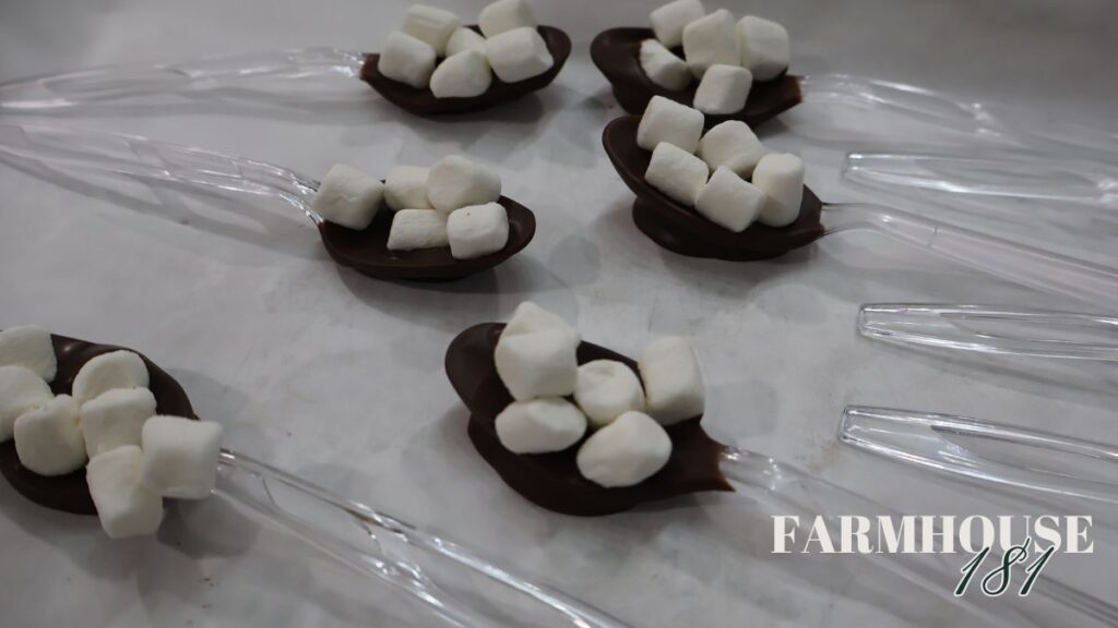 hot chocolate spoons covered in almond bark and topped with mini marshmallows