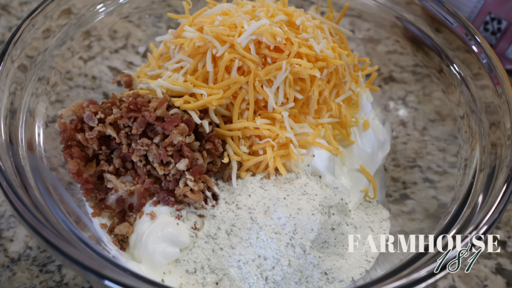 bacon cheddar and ranch dressing seasoning with sour cream in glass bowl