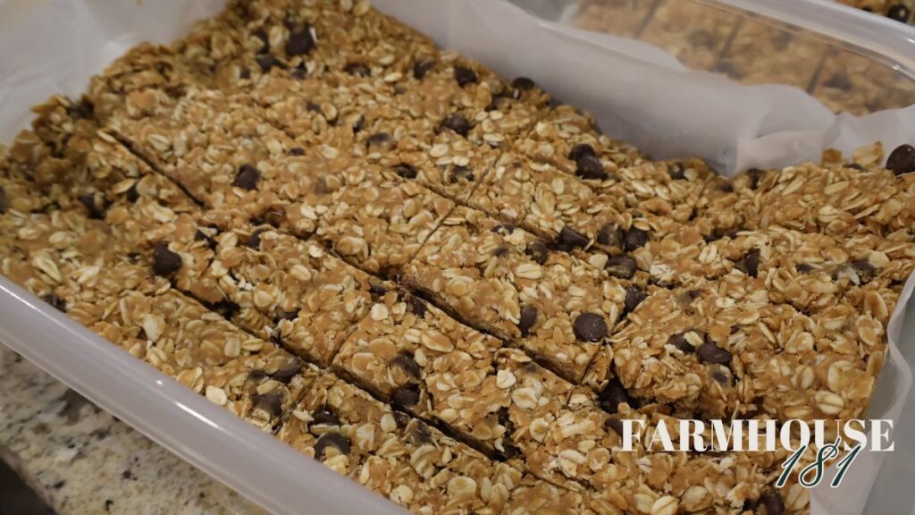 cut granola bars in plastic container divided by parchment paper