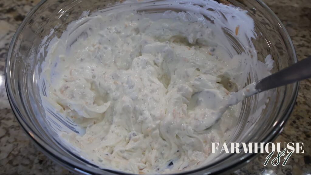 mixing dip in glass bowl with spoon