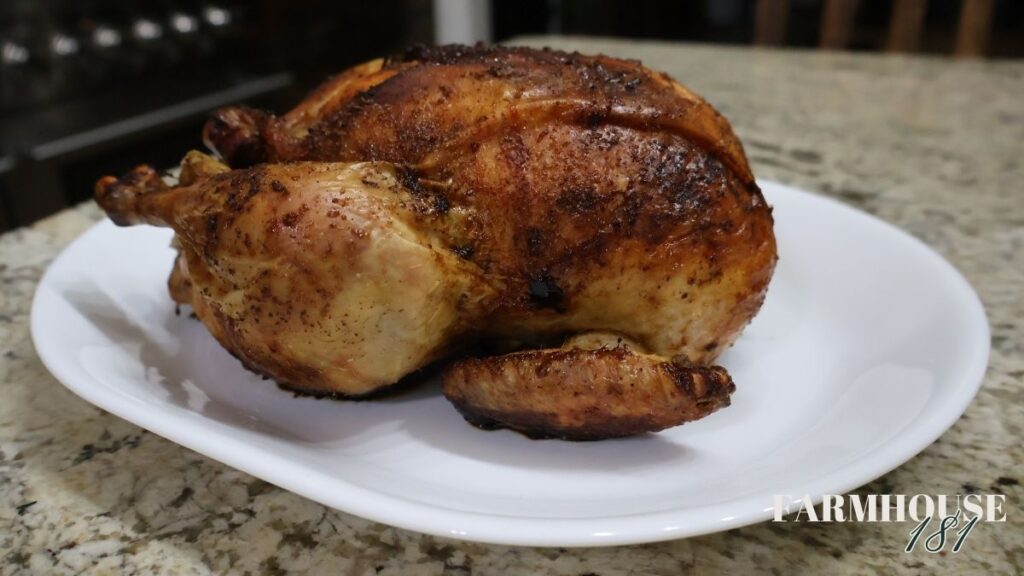 whole roasted chicken on a white platter