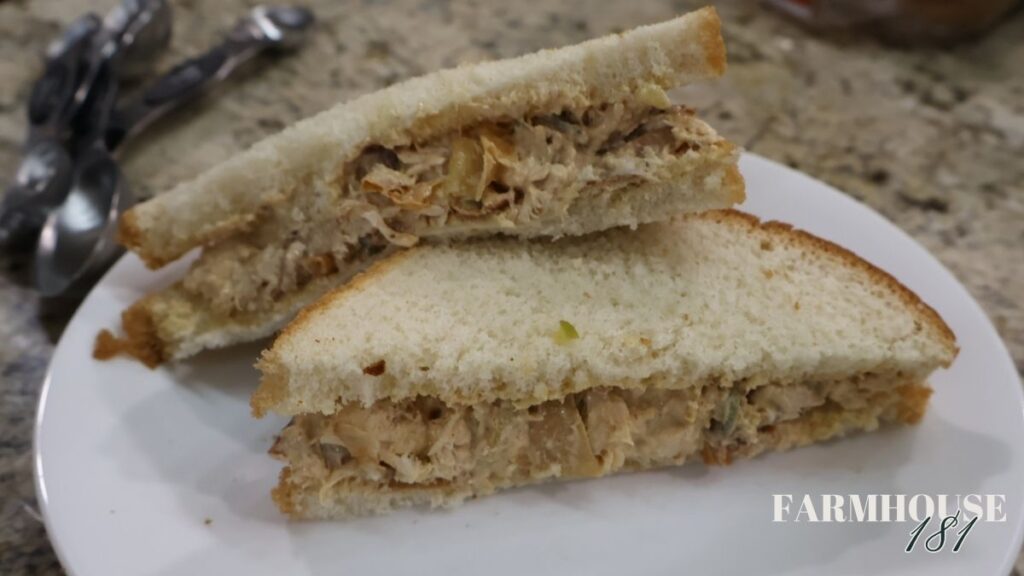 chicken salad sandwich cut in half on plate