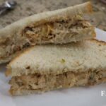 chicken salad sandwich cut in half on plate