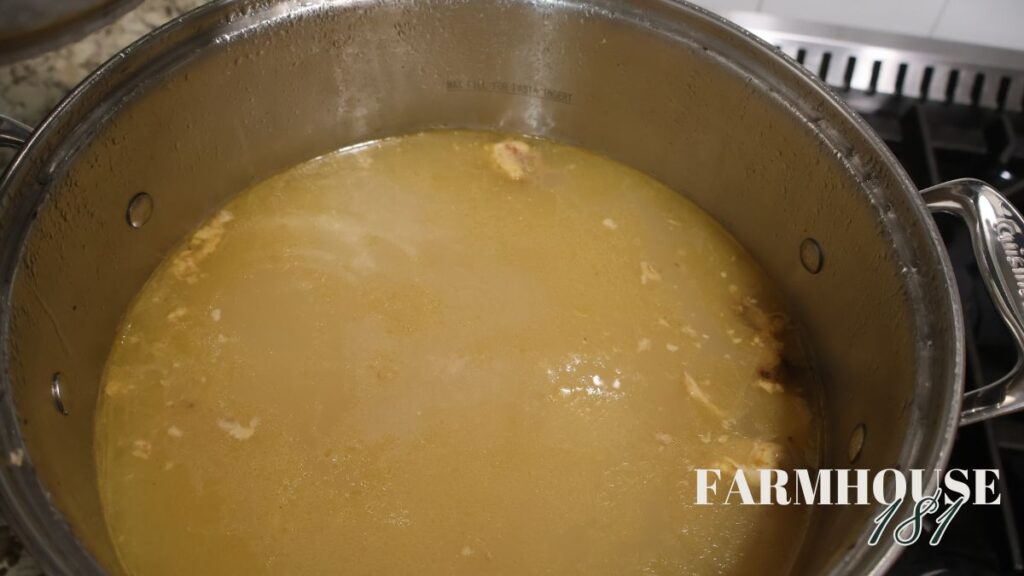 chicken broth heating on the stove in stock pot