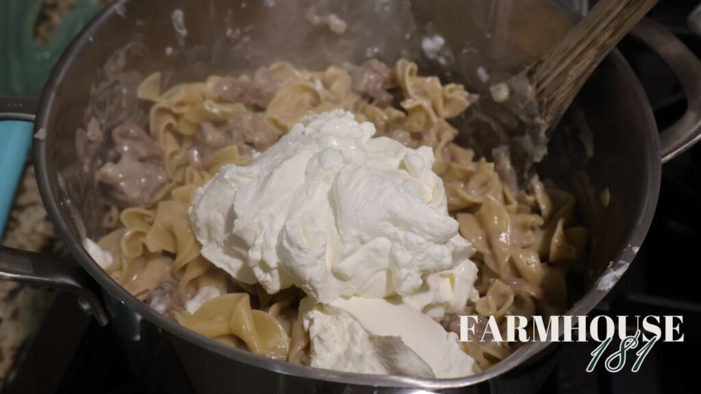 sour cream being mixed into stroganoff
