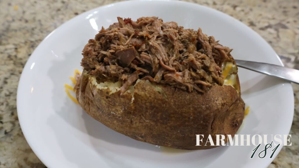texas barbacoa on top of loaded baked potato