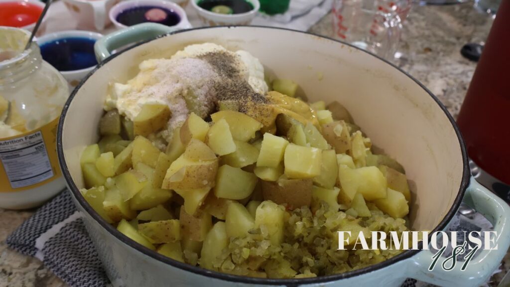 boiled potatoes in pot with potato salad ingredients on top