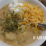 zoomed in picture of potato soup in bowl with toppings
